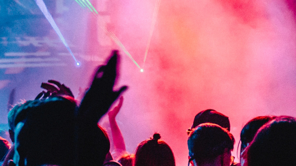 audience dancing, glowing lights
