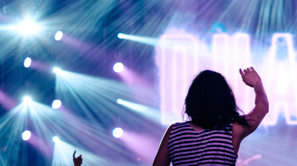 person surrounded by concert flood lights